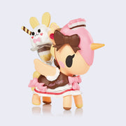 Vinyl "Bunny Sundae" unicorno figure. A light tan unicorn with pink, brown and white color accents similar to neapolitan ice cream, wearing a maid outfit with a decorated sundae on its back.