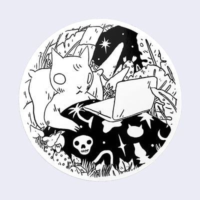 White circle sticker with a drawing of a cat in bed using a laptop. The cat's blanket has a skull and other mystical motifs.