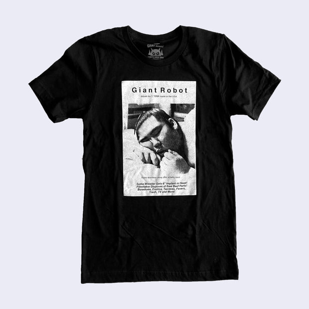 Black t-shirt with a scanned gritty image of Giant Robot Magazine issue #1 cover, with a close up photo of a sumo wrestler sleeping with his cheek resting on his hand. Writing below says, "Sumo wrestlers sleep after a hefty meal" and "Sumo wrestler gets 6" implant in head, filmmaker disposes of raw beef parts, boredoms, exotica, twinkies, fevers, trash, TV and more!"