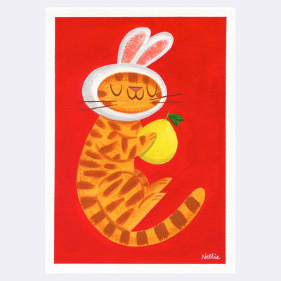 Simplistic illustrative painting on paper, of an orange tabby cat slightly curled into itself, holding a yellow pomelo with its eyes closed. It has a cap around its head of white bunny ears. Background is solid red.