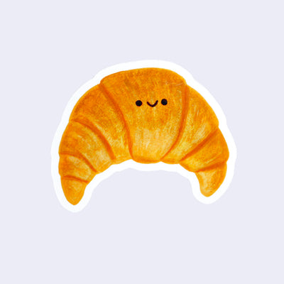 Die cut sticker of a illustration style croissant with a small smiling face.