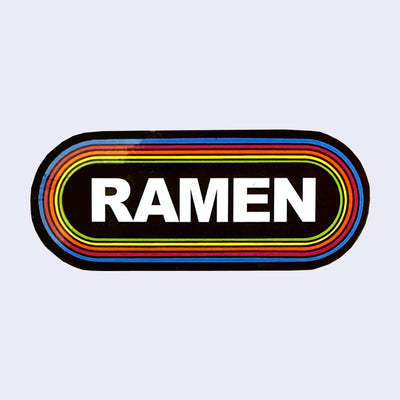 Rounded corner rectangle sticker, black with the word "Ramen" written in bold, all caps white font in the center. It is surrounded by 6 thin lined borders, each a different color of the rainbow.