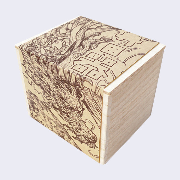 Unstained square shaped wooden box with a thing paper wrap around of with an illustration of a detailed dragon.