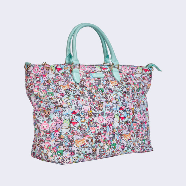 Large purse style tote bag, with mint blue pleather handle and a long mint blue adjustable sling strap. Bag has a small "tokidoki" nameplate on the upper center and is covered completely in a busy pastel color pattern featuring tokidoki characters with cafe food and drink imagery.