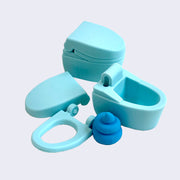 2 blue toilet shaped erasers, one is put together and the other is disassembled into 4 pieces: the lid, the seat, the empty bowl and a swirled blue poo.