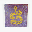 Square ceramic tile with a gold snake on it and pink and purple background with gold splatters.