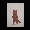 A hand-drawn illustration of a brown cartoon cat standing and holding a cigarette with smoke rising, printed on a white rectangular card against a black background.