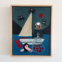 A framed folk art print depicting a whimsical scene of a seal in a boat with a net full of red fish, a mermaid, and crows, mounted on a light wood frame against a white wall.