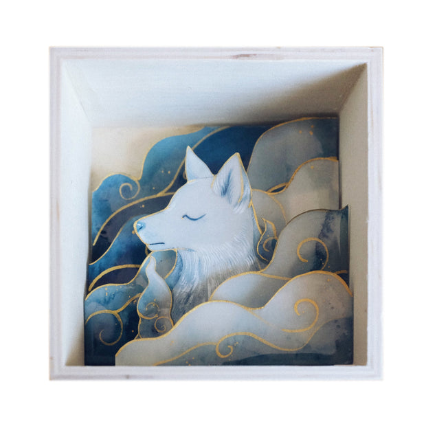 Diorama style artwork of a blue wolf, seen only from the chest up, looking off to the left. It is surrounded by blue watercolor clouds with subtle gold outlining. 