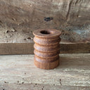 Wooden cup with ridges in its body.
