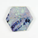 Hexagon shaped ceramic tile with a glossy glaze and a light blue and purple swirl design, with gold splatters as well.