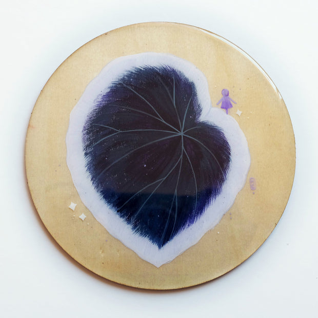 Painting on exposed wooden circle panel of a large begonia petal, dark purple with a white outline. A small simplified silhouette of a woman stands atop of the petal.
