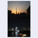 Example page spread from Small Art Society #2, featuring 2 photos of a city skyline at sunset with a prominent tower and below, a photo of a bridge lit up at night..