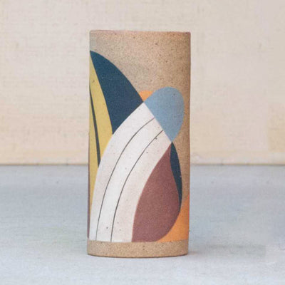 Ceramic vase without any curvature. It is painted in earth tones: burgundy, blue, white and yellow and consists of geometric shapes.