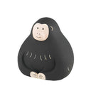 Black monkey figurine with a white face on a white background