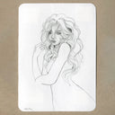 A black and white line art sketch of a woman with long wavy hair, presented on a white rectangular card with rounded corners against a textured brown background.