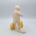 White devil ceramic figure with orange flames on its sides.