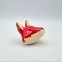 Ceramic fox figurine on a light gray background