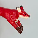 Red fox figurine on a plain background
