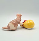 Ceramic mouse and gourd figurine on a plain background