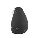 Black monkey figurine with a white face on a white background