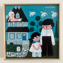 A framed square folk art style painting of a whimsical illustrated family scene. The artwork shows a man and child standing in front of a house, with another person sitting on the roof and white birds flying in the sky.