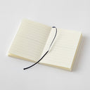 Open notebook with lined pages and a black fabric marker ribbon.