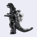 A glossy black Godzilla toy figure with textured scales and a metallic silver-gray dorsal fin, standing on a light gray background.