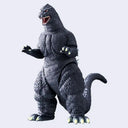 A detailed Godzilla action figure or collectible toy shown against a plain light gray background. The figure is dark gray with textured skin, glowing red eyes, an open mouth showing white teeth, and light green claws on its feet and hands.