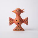 Orangish red ceramic sculpture of a figure of a bird-like creature, with triangle arms, a triangle base and a round body. Its head point to the side with a beak and feathers atop its head.