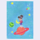 A colorful drawing of a girl standing on a red ringed planet and holding a yellow crescent moon, set against a blue space background with stars and planets.