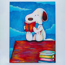 Colorful illustration of Snoopy, sitting atop of his red dog house reading a book, a pile of books sits nearby. The sky is blue with blue clouds.