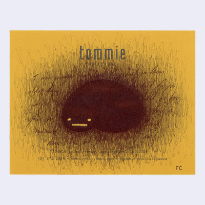 Scribbled ink drawing on yellow paper of a black bob, covering writing.