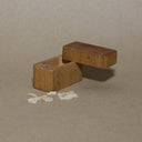 Wooden box with tiny wooden die cut items of weapons, and skulls. 