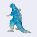 A translucent blue and white Godzilla figure, shown in a side profile against a light gray background.