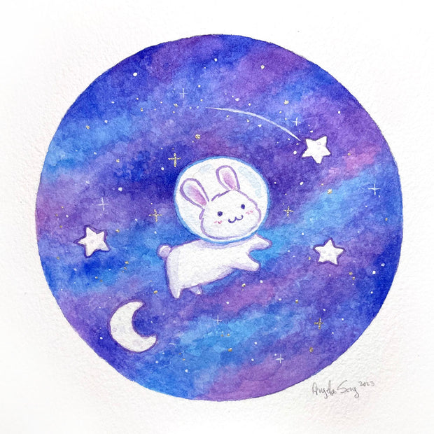 Watercolor painting of a blue and purple circle, mimicking space. A small, cute white rabbit floats through it with a space helmet. A falling star is nearby.