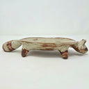 Ceramic vessel like a shallow plate with 4 legs and a raccoon head at the front of the plate.