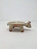 Ceramic plate or very shallow vessel, with a boar's head in the front and 4 legs that act as stands for the plate, attached. 