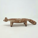 Ceramic plate or very shallow vessel, with a brown raccoon head in the front and 4 legs that act as stands for the vessel, attached. It has a fluffy, long tail.