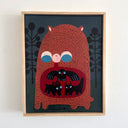 A framed folk art painting of a stylized red bear, with the contents of its stomach visible to the viewer. Inside its stomach is a black bird, rabbit and a black cat.
