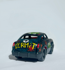 Small black toy car with "Kermit" written on the back in yellow ink.