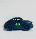 Small black toy car with a painting of Kermit the Frog on the front, roof and asides with red star patternings.