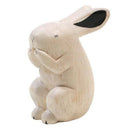 Carved wooden figure of a white rabbit.