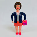 Clay sculpture of an office woman, wearing her office clothes with a blue jacket atop and holding a bento takeout box in a bag.