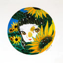 Painting of a cartoon style girl with shiny, yellow and brown eyes looking out from a cluster of growing sunflowers.