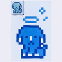 Illustration of a pixel art dog with a halo. Overhead is a tiny cross stitch version of the same image.