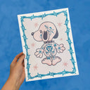 Risograph print of Snoopy, facing away from the viewer and covered in tattoos. He wears a spiked collar and has a barbed wire border around the piece.