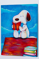 Colorful illustration of Snoopy, sitting atop of his red dog house reading a book, a pile of books sits nearby. The sky is blue with blue clouds.