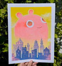 Illustration of a pink creature looming very largely with a cute, innocent smile over a city skyline on a yellow background