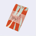 Textile product with a brand logo on a light gray background